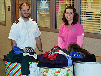 Lt. Josh Brookman of The Salvation Army and Lisa Marsee of Van Wert Medical Services with barrels of donated coats. (photo submitted)