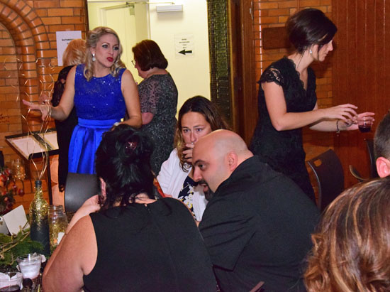 YWCA of Van Wert County Executive Director Kimberly Laudick (in blue) greets those who attended Friday's gala celebrating the organization's 100th anniversary. Dave Mosier/Van Wert independent