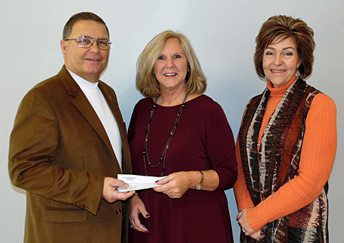 Stacy Adam (center) presents a check for $50,000 to Convoy Foundation President Greg Kulwicki and Trustee Marcia Germann. (photo submitted)