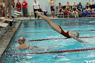 Van Wert swimmer Peyton Fleming dives in over teammate Katie McVaigh to begin the last leg of the 200-meter individual medley relay. (photo submitted)