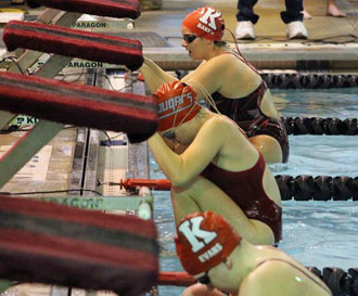 Van Wert swimmer Emma Verville (center) gets ready to compete against Kenton swimmers in the 100-yard backstroke. (photo submitted)
