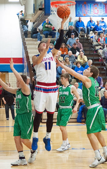 Crestview's Derek Stout (11) puts in a reverse layup against three Celina defenders during Saturday's homecoming contest won by the Knights. Bob Barnes/Van Wert independent