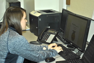 FFA advisor Ericka Priest finishes up posters for this year’s FFA week. (Photo submitted.)