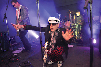 Participants of all ages who attended the Enchanted! Opening party at the Wassenberg Art Center gathered around the makers table to create fairy doors. Diane Bendele, ArtReach afterschool art program instructor assists. (Photo submitted.)