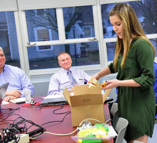 VWHS freshman Alaina Arney shows her invention to school officials at Wednesday's meeting of the Van Wert City Board of Education. Dave Mosier/Van Wert independent