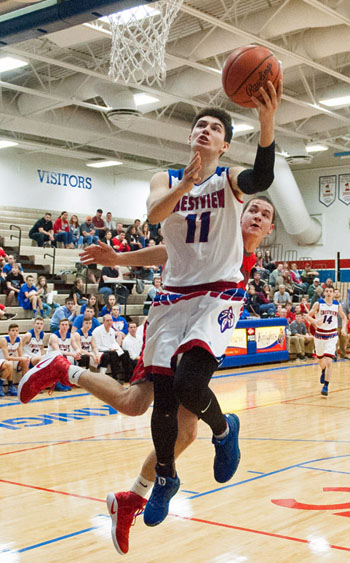 Crestview's Derek Stout (11) puts in a layup over a New Knoxville defender during Saturday's non-conference game at Ray Etzler Gymnasium. Bob Barnes/Van Wert independent