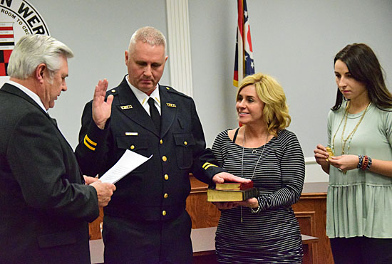 Captain Jon Jones is administered the oath of office as fire chief by Mayor Jerry Mazur, while Jones' wife, Ellen, holds the bible, and daughter Riley holds his chief's badge she will later pin on him. Dave Mosier/Van Wert independent