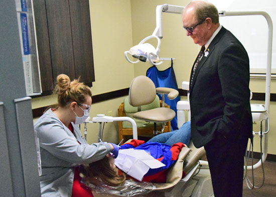 American Dental Association President-elect Dr. Joe Crowley watches as a local youngster receives dental services Friday at the Van Wert Smiles dental clinic. Dave Mosier/Van Wert independent