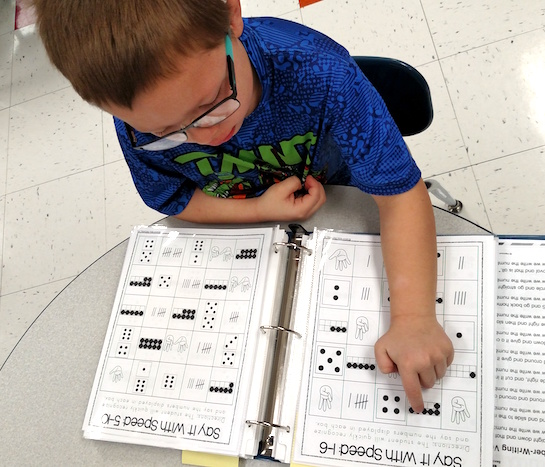 Students in Kindergarten practice recognizing numbers as fast as they can! They are looking at ten frames, fingers, tally marks and dice. (Photo submitted.)