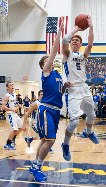 Lancer Ryan Rager (5) puts up a shot over a Delphos St. John's defender in Friday's non-conference game won by the Blue Jays 59-41. Bob Barnes/Van Wert independent