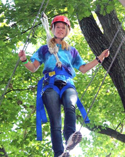 Counselor Sophie Wilson works with her team through the high ropes course at 4-H camp. (photo submitted)