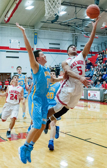 Van Wert junior Jacoby Kelly (5) evades a Lima Bath defender to put in a layup during the Cougars' 58-56 win over the Wildcats. Bob Barnes/Van Wert independent