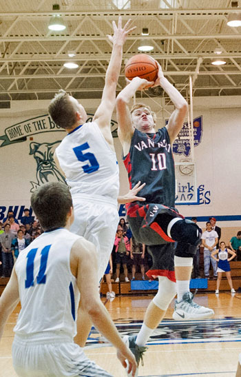 Van Wert's Nate Place (10) puts up a shot over a Defiance defender in a 49-48 Cougar win over the Bulldogs. Bob Barnes/Van Wert independent