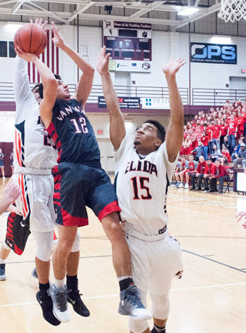 Van Wert's Nick Gutierrez (12) goes up for a shot in traffic during Friday's Division II sectional finals game with Elida at Paulding High School. The Bulldogs won the game, 64-58. Bob Barnes/Van Wert independent