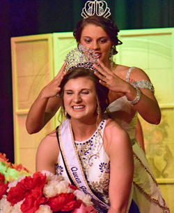 Queen Jubilee XLI Ashton Bowersock (behind) crowns Katlyn Wendel Queen Jubilee XLII during Friday's Peony Festival Pageant at the Marsh Foundation.