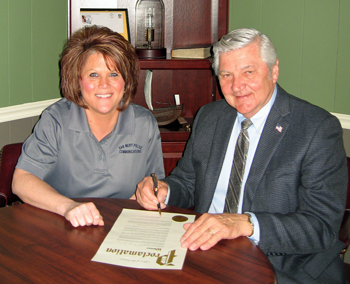 Van Wert Police Department Dispatcher Shelly Smith is shown with Mayor Jerry Mazur, as he signs a proclamation designating National Telecommunications Week. (photo submitted)