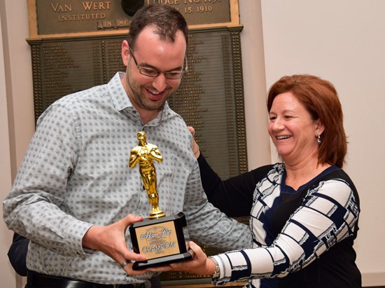 Former Main Street Van Wert program manager Adam Ries is presented the "Downtown Champion" award by Jana Ringwald of Central Insurance Company. photos by Dave Mosier/Van Wert independent