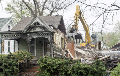 Just a small portion of the house remains as demolition proceeds on Friday. Bob Barnes/Van Wert independent