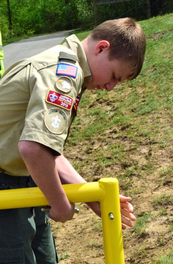 Boy Scout Cole Gorman places pins in a gate to secure it to its base on Friday. Dave Mosier/Van Wert independent