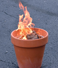 The Council on Aging mortgage burns in a clay pot. 