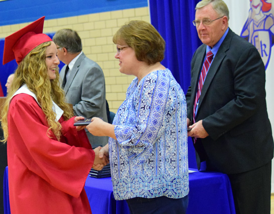 Crestview senior Cora Millay receives her diploma from Board of Education Member Lori Bittner, while high school Principal Mike Biro (background left) and Superintendent Mike Estes look on. Dave Mosier/Van Wert independent