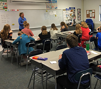 Alyssa Evans (standing) explains her responsibilities at the Gaylord E. Leslie Wellness Center to a group of middle school students. Evans was one of 10 presenters at the Lincolnview Middle School Career Day. (Lincolnview photo)