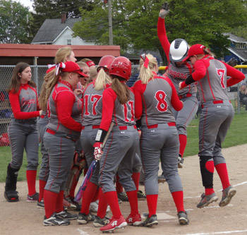 Laine Spoor is greeted by her teammates, after opening Tuesday's game wtih a home run. Scott Truxell/Van Wert independent