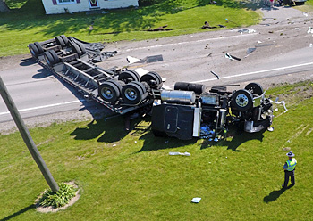 A trooper from the Van Wert Post of the Ohio State Highway Patrol looks over an overturned semi on Tuesday afternoon. Rick McCoy for the Van Wert independent