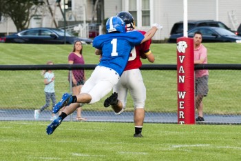 Crestview's Chase Clark leaps to tackle a WBL All-Star. Bob Barnes/Van Wert independent