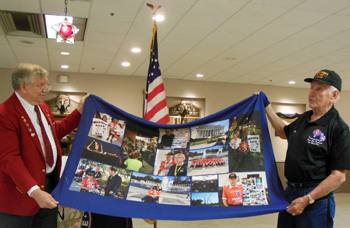 Milo Wyandt (right) and Exalted Ruler Charles White showing Wyandt’s flag. (Elks photo)